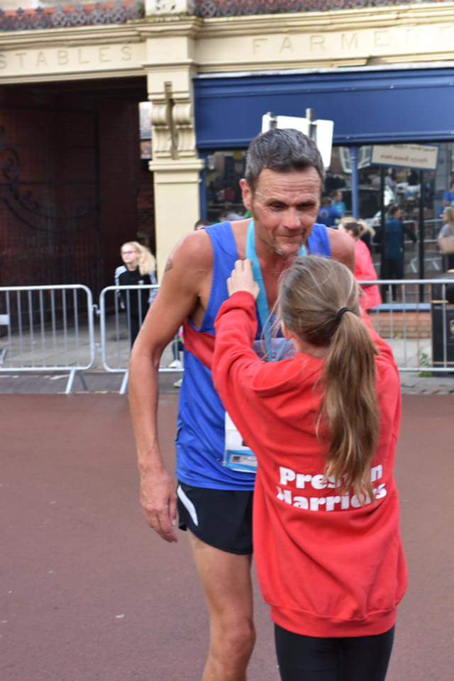 2016 Isabelle Duckett presents medal to Gary Pennington at Run Preston